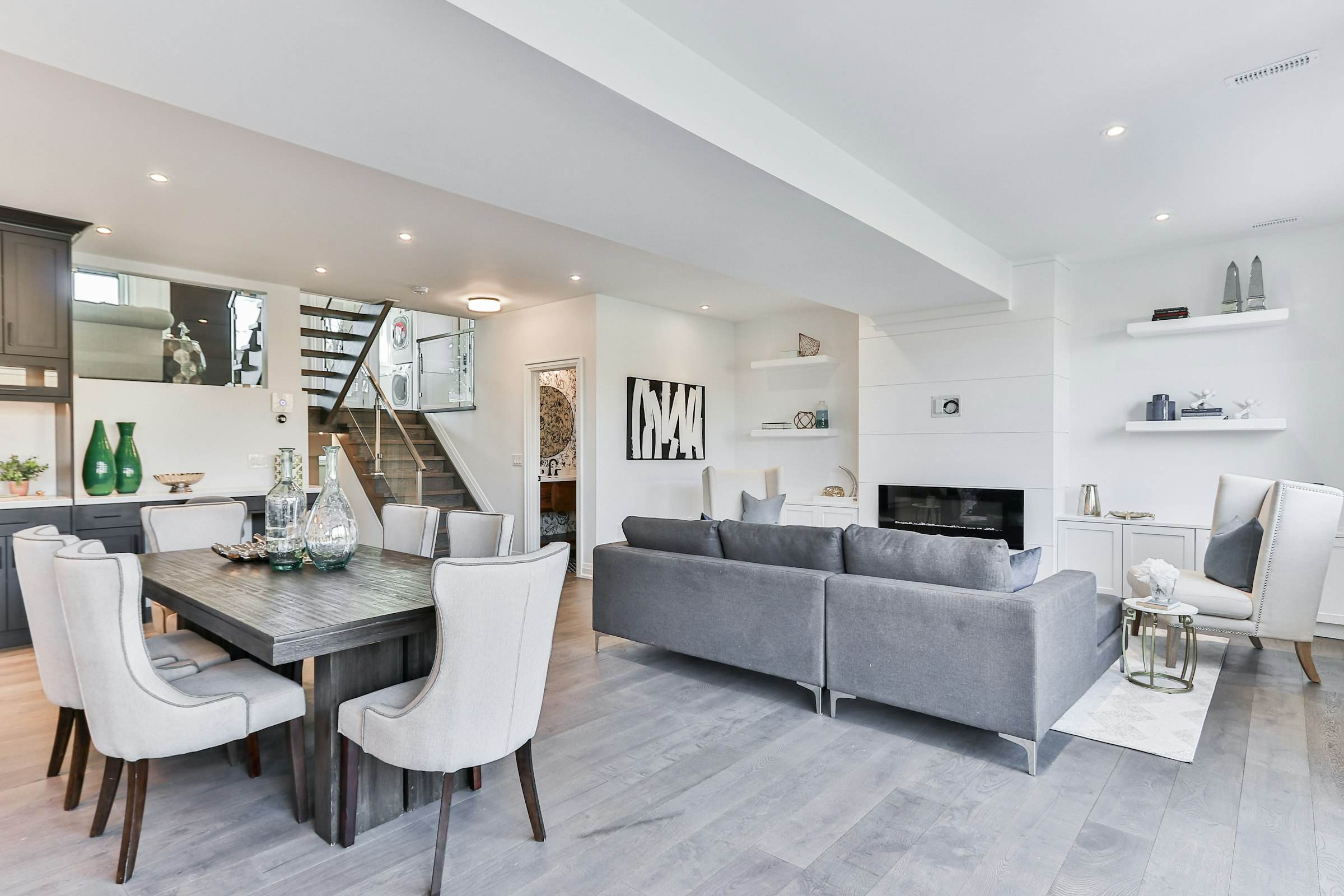 A dining table and grey sofa in an open-plan living and dining space